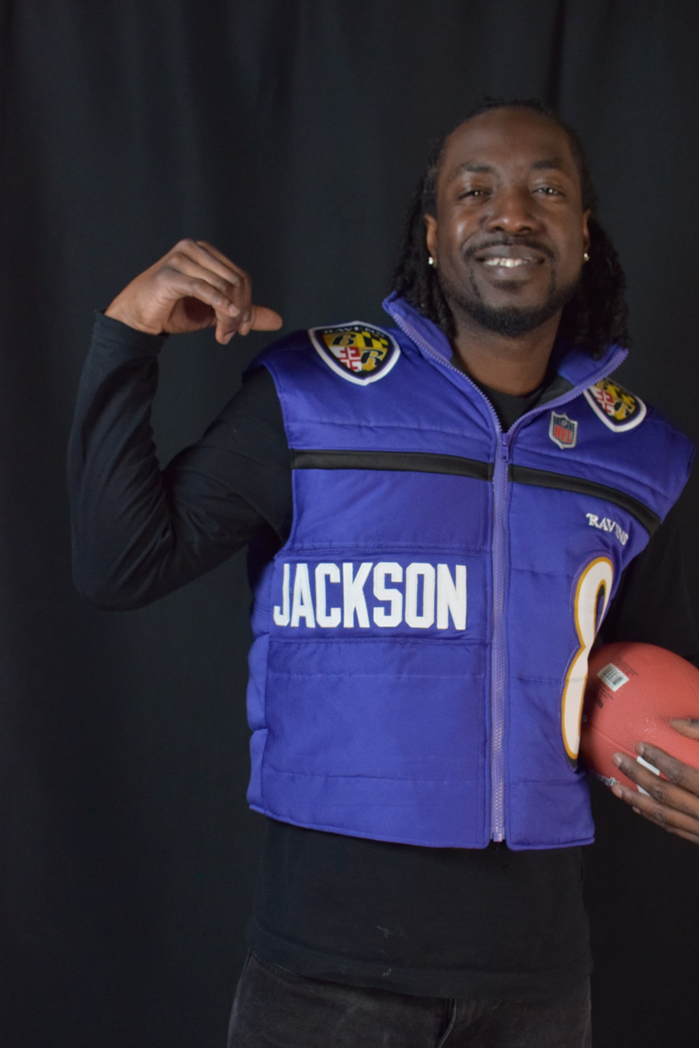Custom TMADE puffer vest built from a Baltimore Ravens Jackson number 8 jersey