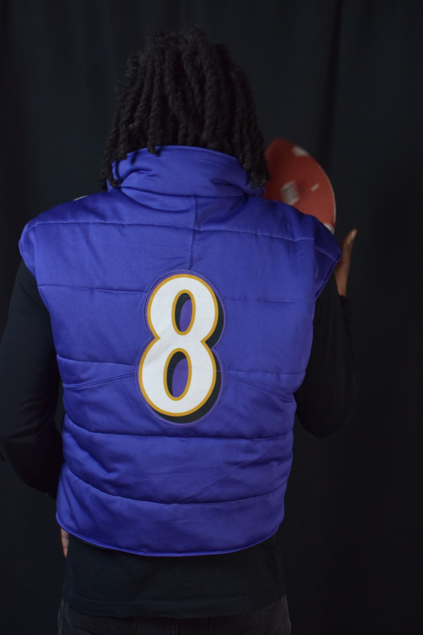 Custom TMADE puffer vest built from a Baltimore Ravens Jackson number 8 jersey