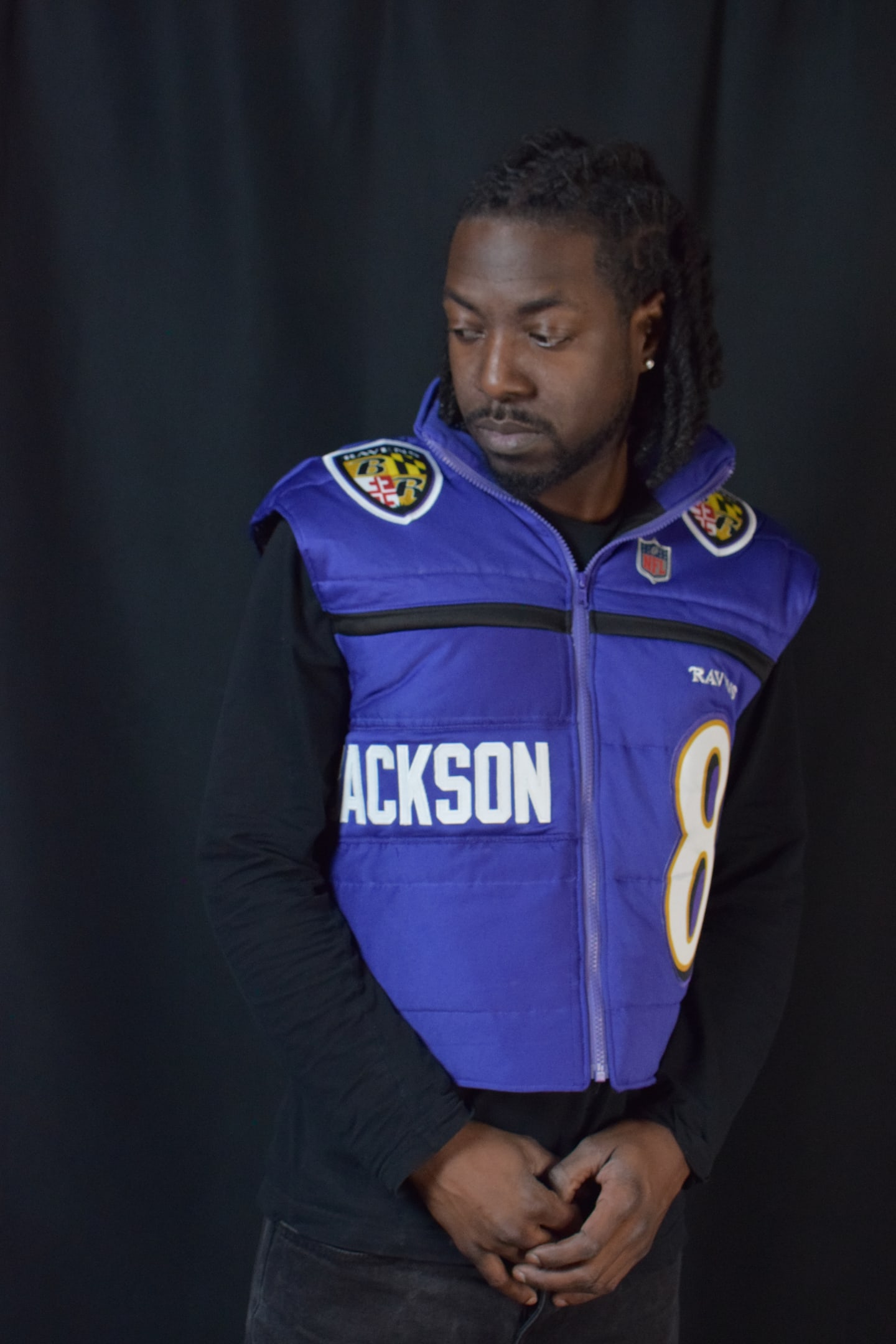 Custom TMADE puffer vest built from a Baltimore Ravens Jackson number 8 jersey
