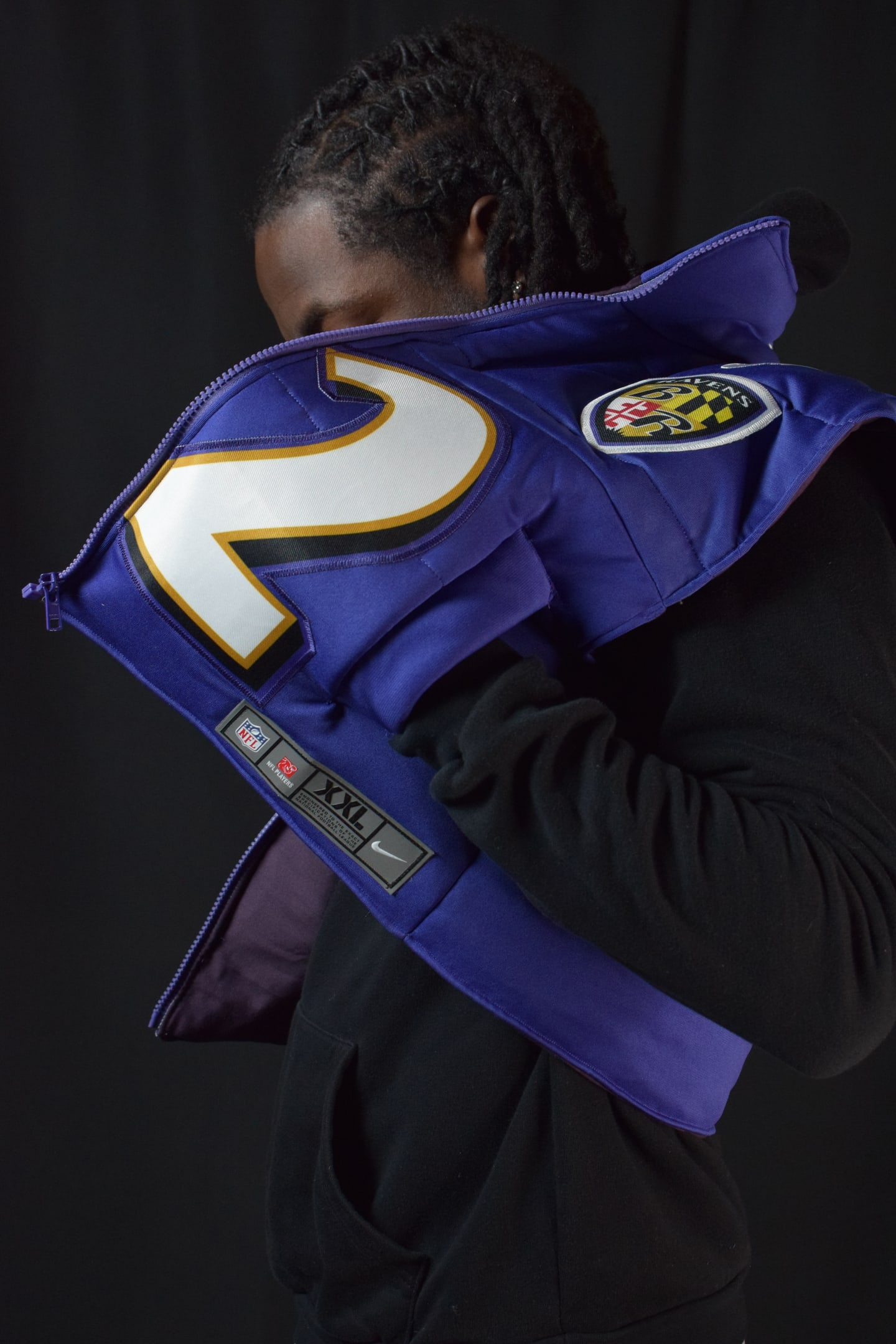 Custom TMADE puffer vest built from a Baltimore Ravens Henry number 22 jersey