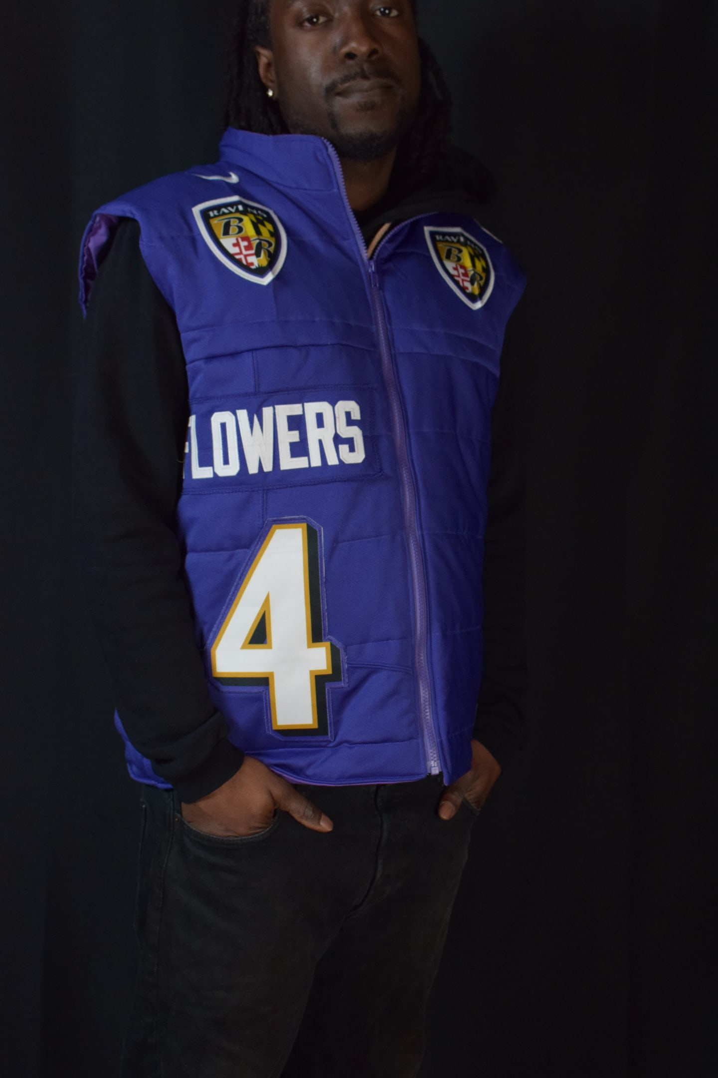 Custom TMADE puffer vest built from a Baltimore Ravens Flowers number 4 jersey