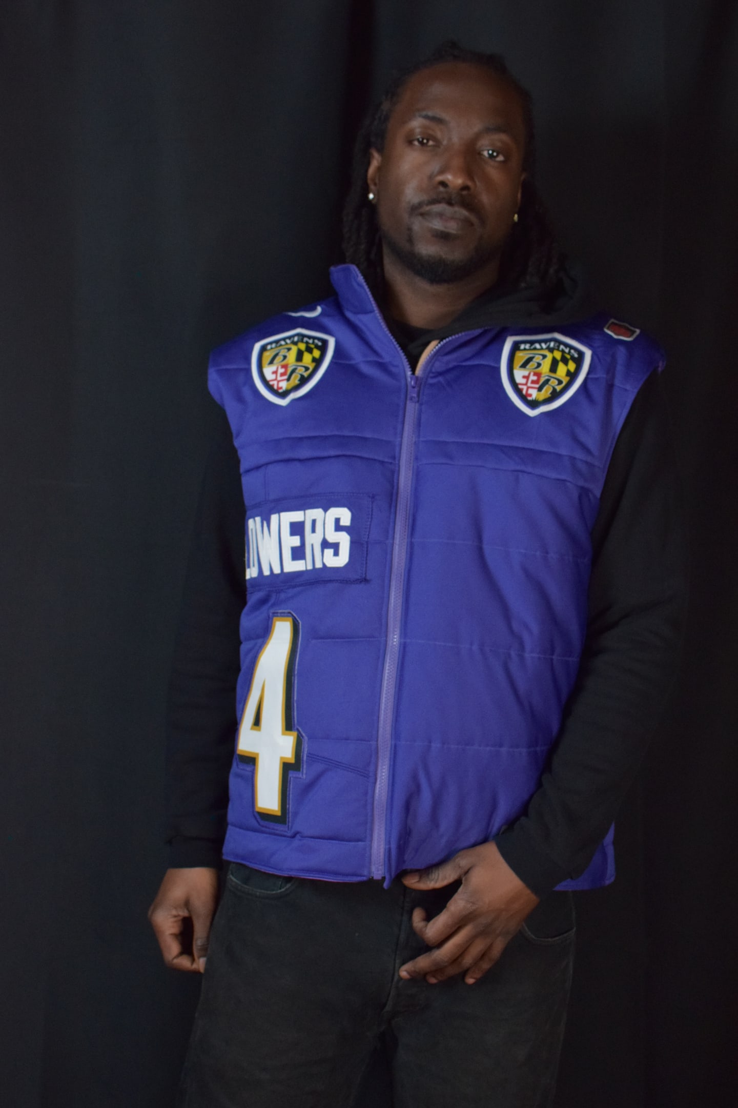 Custom TMADE puffer vest built from a Baltimore Ravens Flowers number 4 jersey