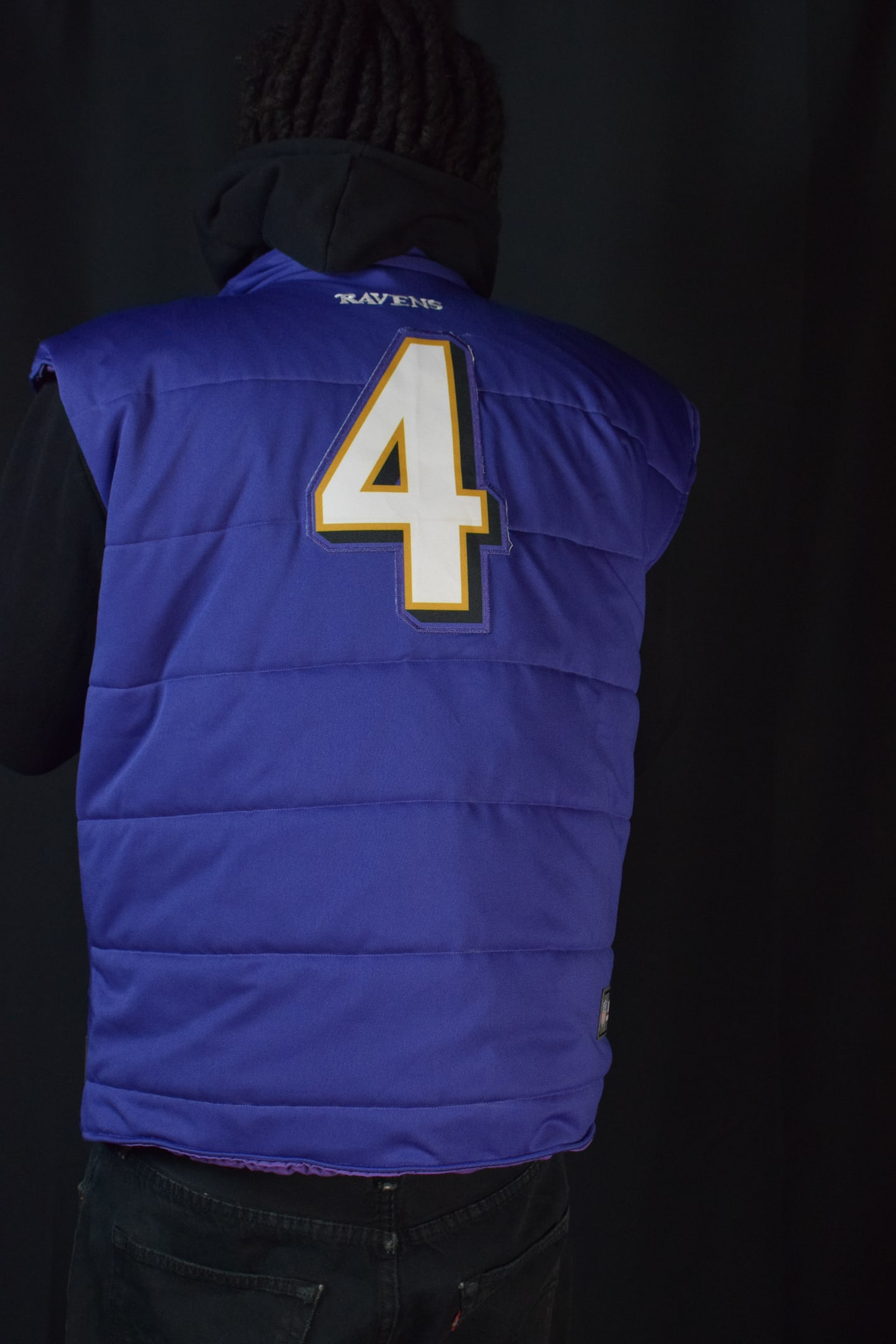 Custom TMADE puffer vest built from a Baltimore Ravens Flowers number 4 jersey