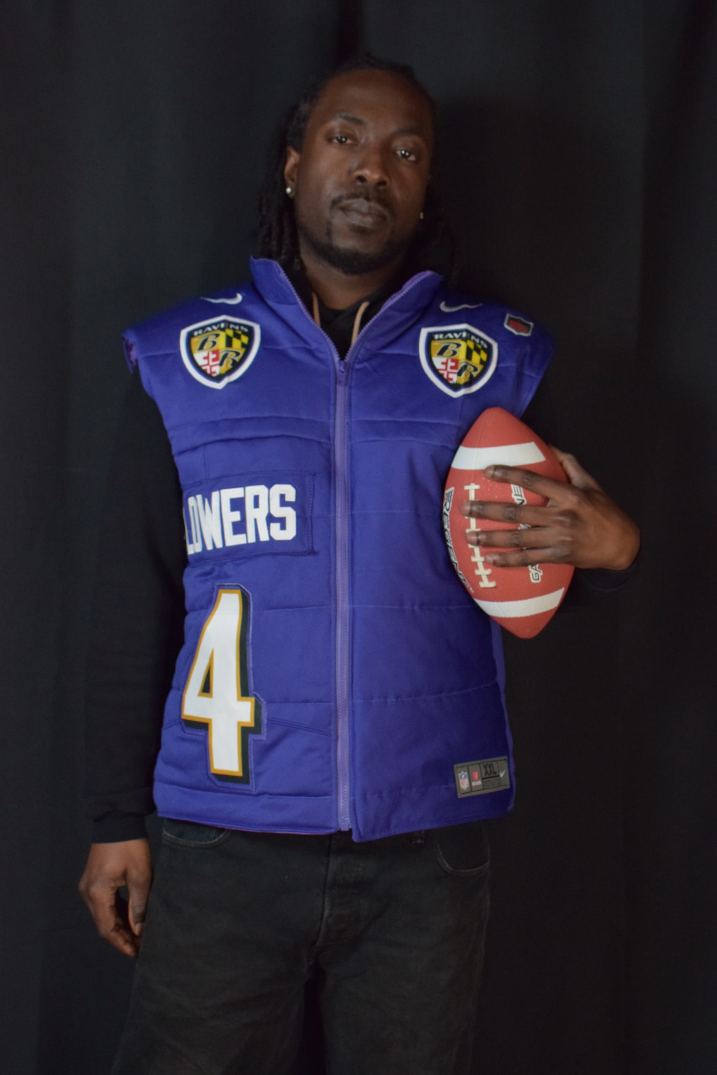 Custom TMADE puffer vest built from a Baltimore Ravens Flowers number 4 jersey