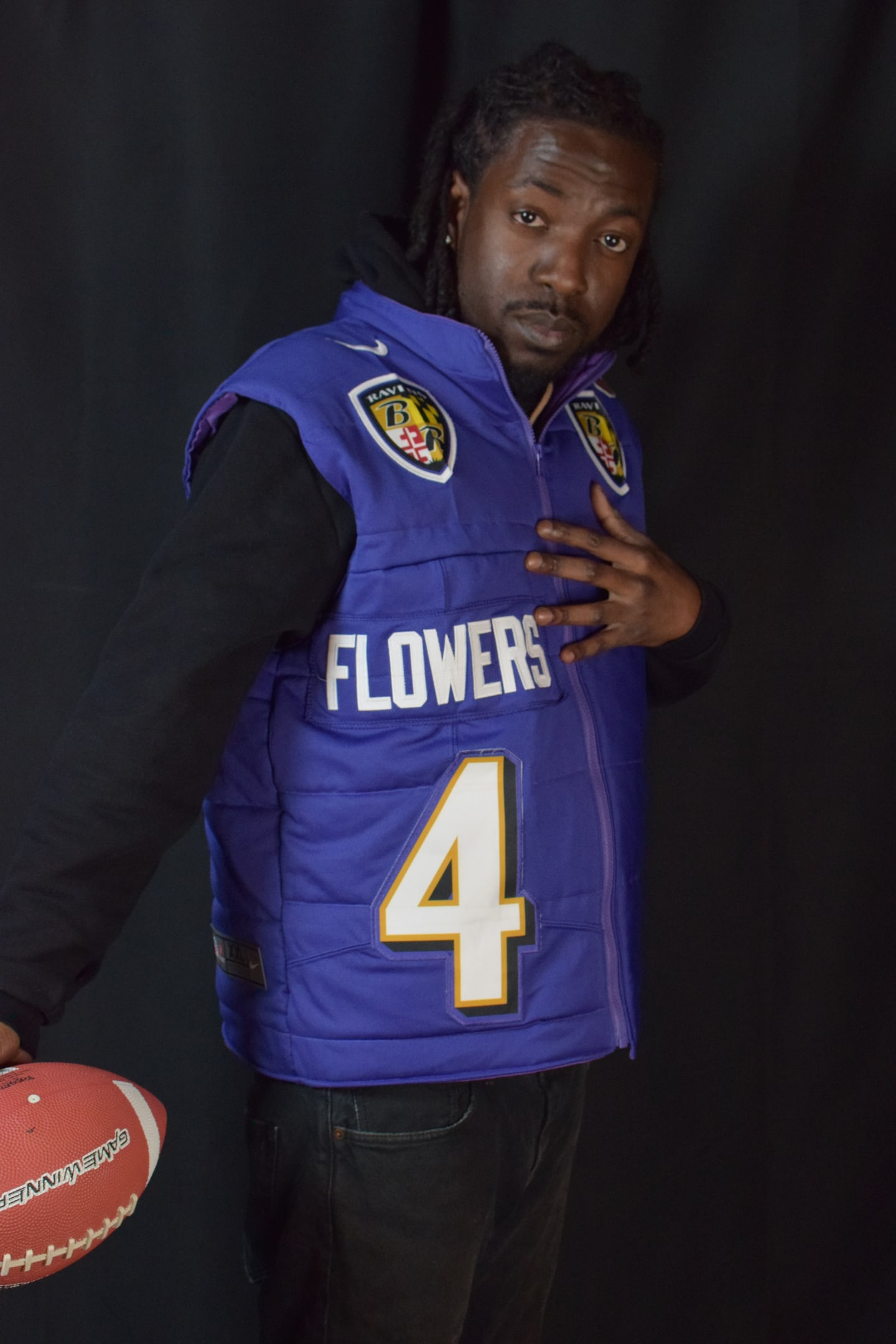 Custom TMADE puffer vest built from a Baltimore Ravens Flowers number 4 jersey