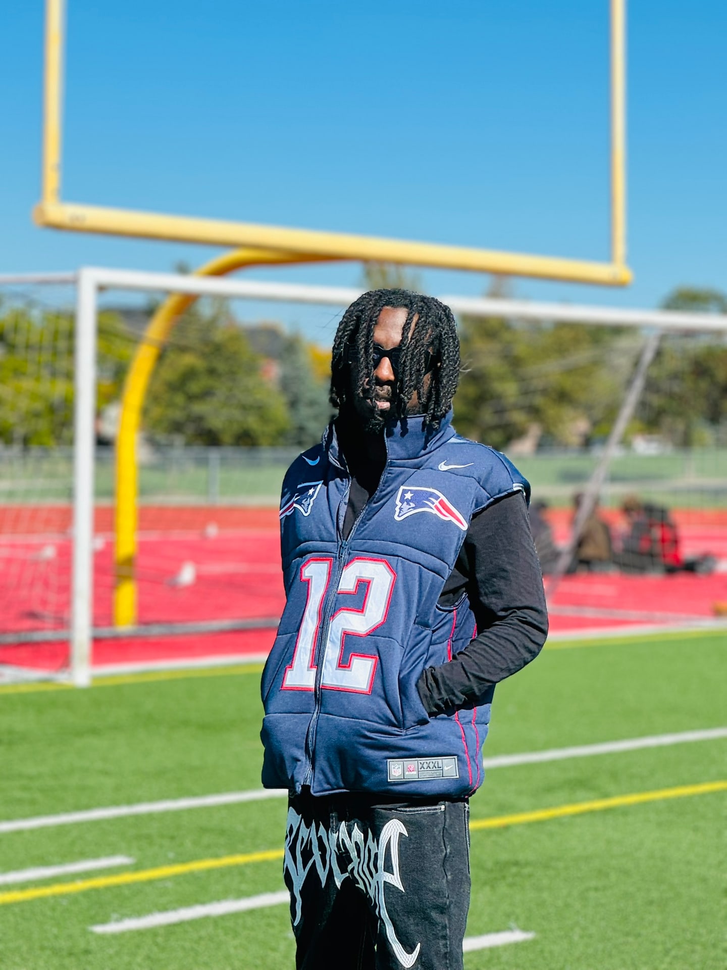 Custom TMADE puffer vest built from a New England Patriots Brady number 12 jersey