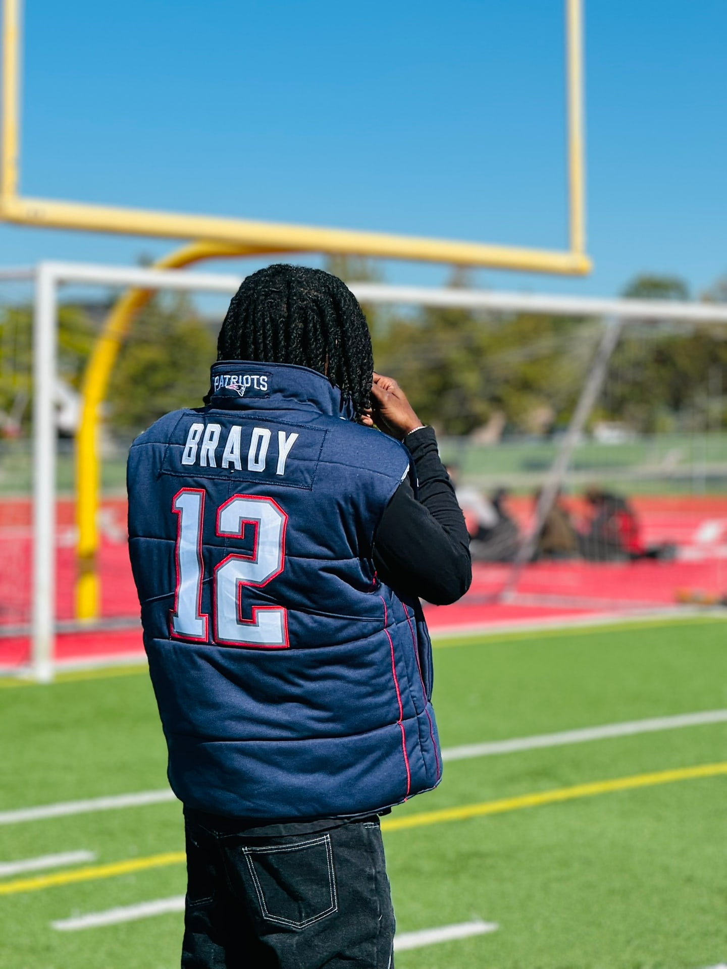 Custom TMADE puffer vest built from a New England Patriots Brady number 12 jersey