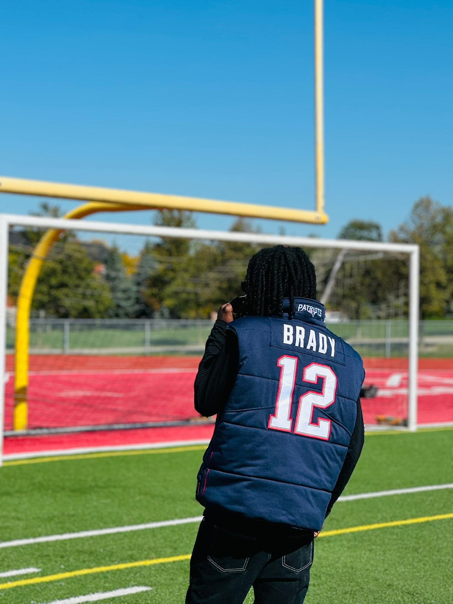 Custom TMADE puffer vest built from a New England Patriots Brady number 12 jersey